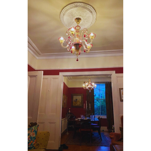 Clear and red Murano glass chandelier in a vintage dining room setting