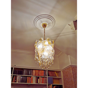 Amber-colored Murano glass chandelier detail hanging gracefully in a library setting