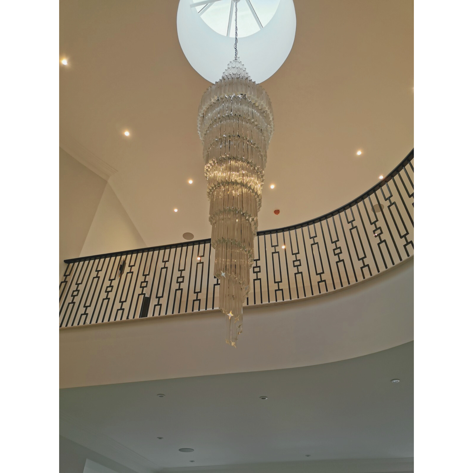 Full view of the 300cm Double Spiral Murano Quadriedri Chandelier installed under a skylight, illuminating the space