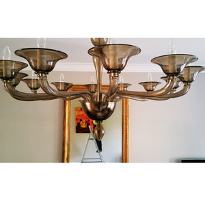 Close-up view of a 12-arm smoke glass chandelier in a classic room.