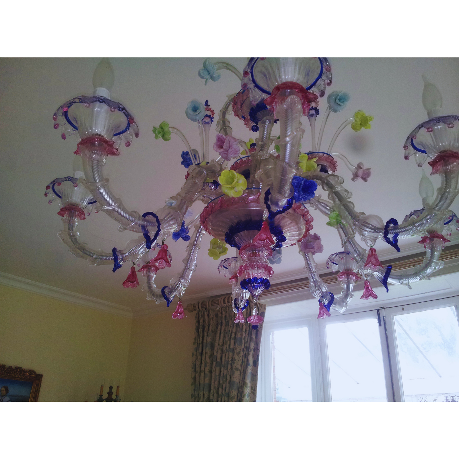 Classic Three-Tier Murano Glass Chandelier illuminating a stairwell with soft, translucent light.