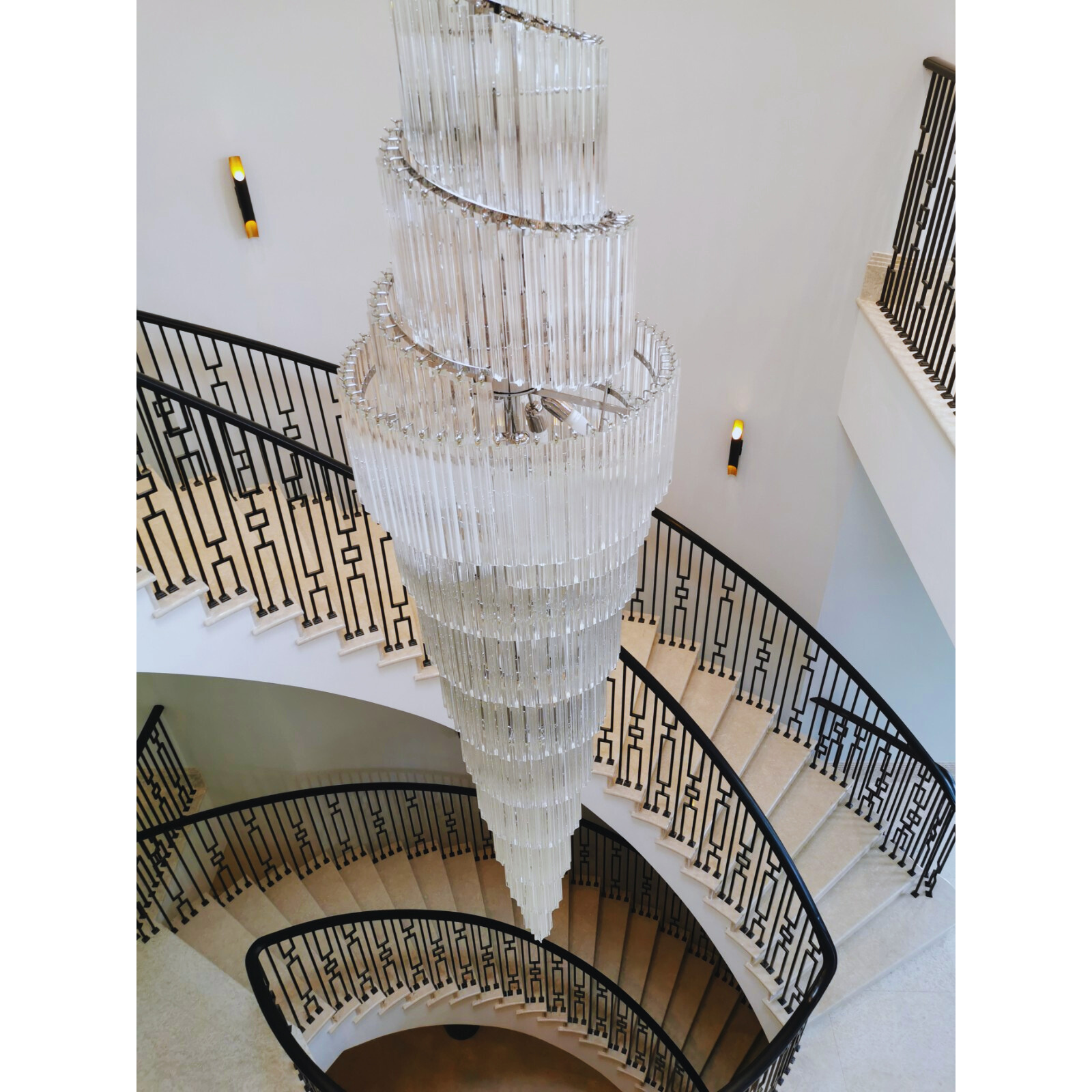 300cm Double Spiral Murano Quadriedri Chandelier with a cascading design, viewed from above a spiral staircase