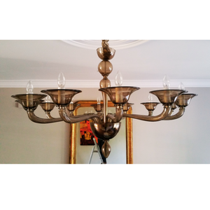 Front-facing image of a smoke glass chandelier with a symmetrical design.