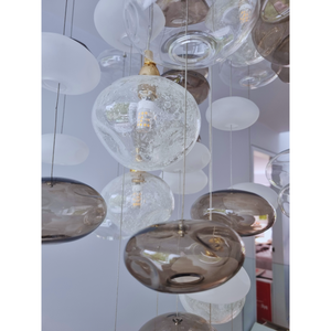 Close-up view of frosted and clear glass bubbles on a bubble chandelier, highlighting intricate details.