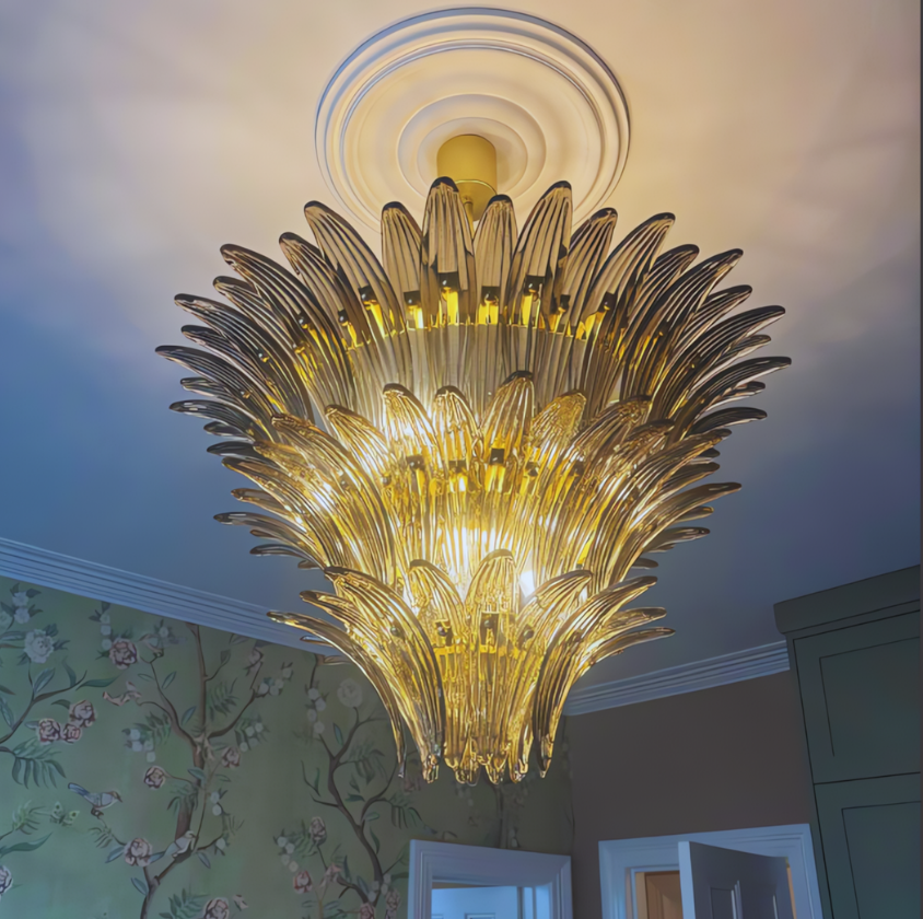 Bespoke Palmette Murano Chandelier with golden glass leaves illuminated in a mid-century styled room.